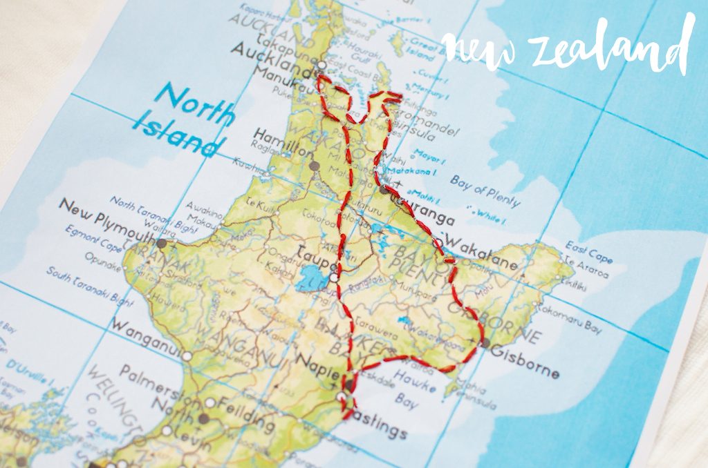 A map of the north island of New Zealand wth a route stitched into the map with red thread.