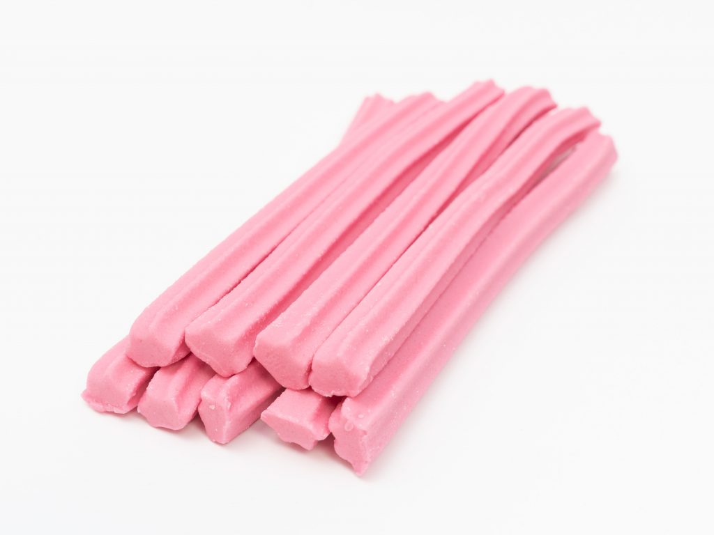 A pile of pink Musk Stick candies.