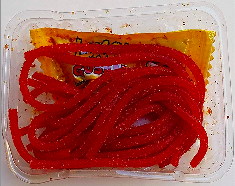 An open box of salsagheti gummy rope candy, including sauce packet.