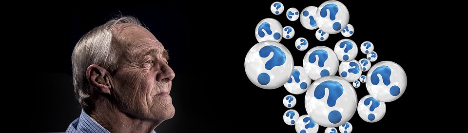Black background with a contemplative older man and blue question marks in bubbles floating by.