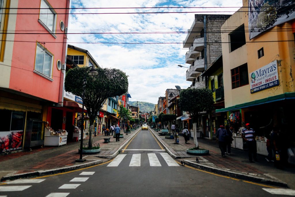 City street in Ecuador with colorful buildings.