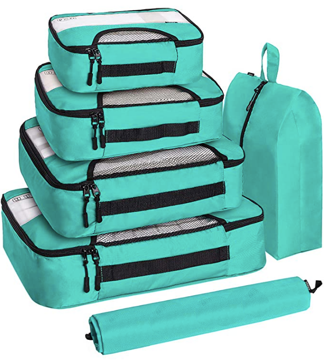 A set of different sized teal packing cubes.