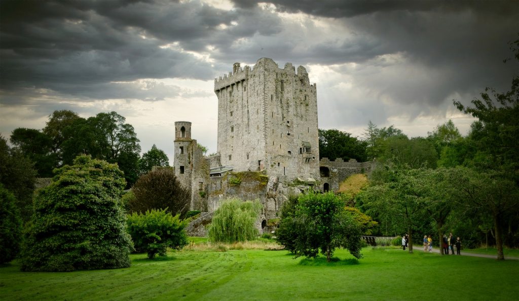 Blarney Castle in Ireland with dark clouds in the sky.