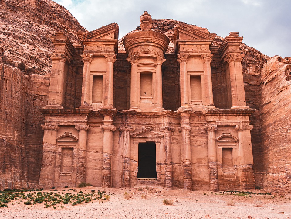 A pink stone building carved from a cliffside at Petra in Jordan.