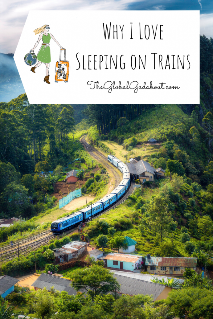 Train curving through a mountainous region with a few buildings beside the tracks. A white luggage-tag shape overs the top with The Global Gadabout logo and the words "Why I Love Sleeping on Trains" and "TheGlobalGadabout.com".